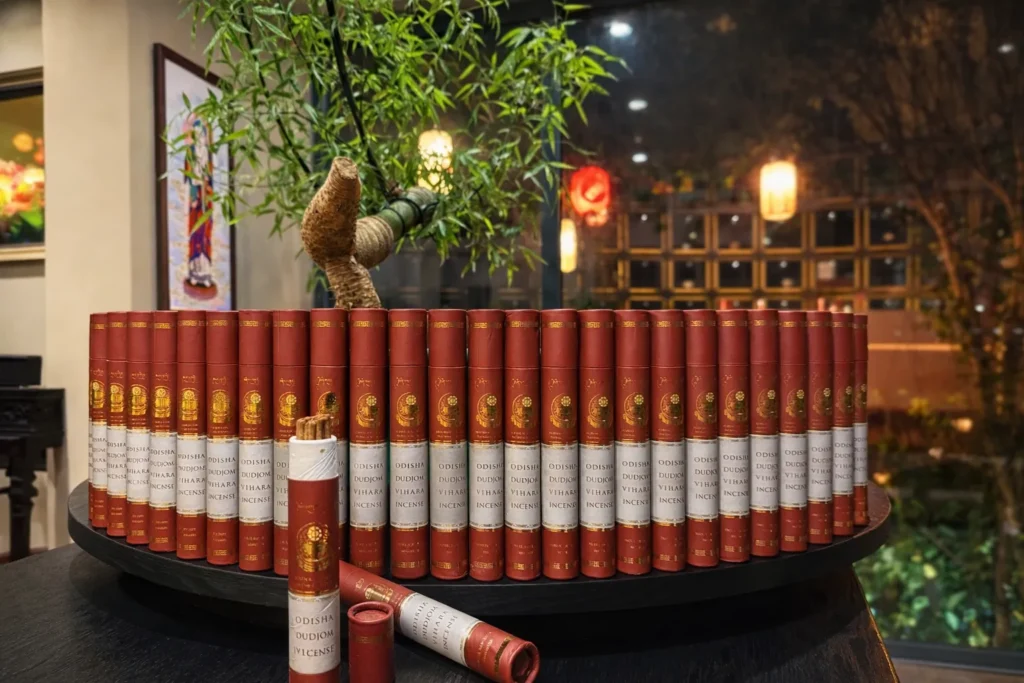Rows of Dudjom Vihara incense tubes displayed on a round table